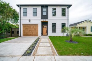 Beautiful southern-style home with a large front porch, typical of Mandeville or Covington, Louisiana, on a bright, sunny ...